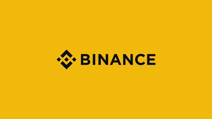 The image displays the Binance logo, featuring its iconic diamond-shaped icon alongside the "BINANCE" wordmark, centered on a bright yellow background. This visual celebrates Binance's nine-year milestone as the company has grown from a startup exchange into a global cryptocurrency powerhouse.