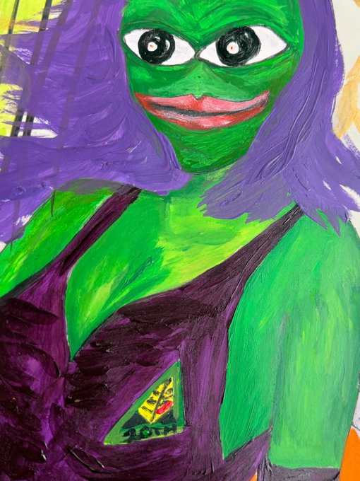 A colorful painted portrait depicts a green-skinned figure with purple hair, large eyes, a wide smile, and a purple garment with a triangular emblem.