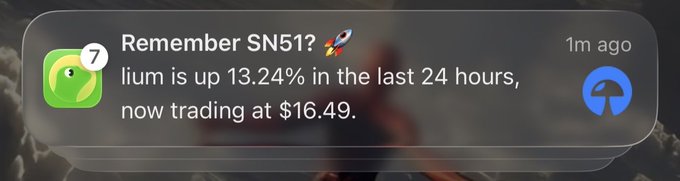 An iPhone notification from the Robinhood app reads: 'Remember SN51? 🚀 Ilium is up 13.24% in the last 24 hours, now trading at $16.49.'