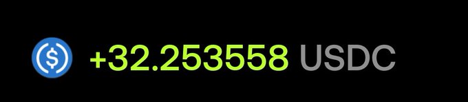 A graphic displaying a USDC cryptocurrency balance with a blue coin logo and green text reading '+32.253558 USDC' on a black background.