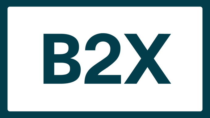 A simple graphic with a dark teal border containing the text 'B2X' in bold dark teal letters on a white background.