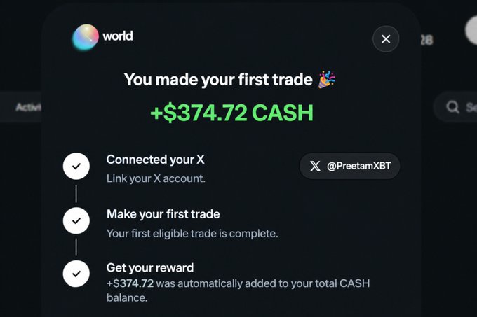 A screenshot of a "World" app notification celebrating a first trade, showing a reward of "+$374.72 CASH" with three completed steps: connecting X account @PreetamXBT, making the first eligible trade, and receiving the cash reward. The image confirms the "$374" cash reward mentioned in the caption, which thanks @world_xyz for the stimulus-style payout from completing their onboarding promotion.