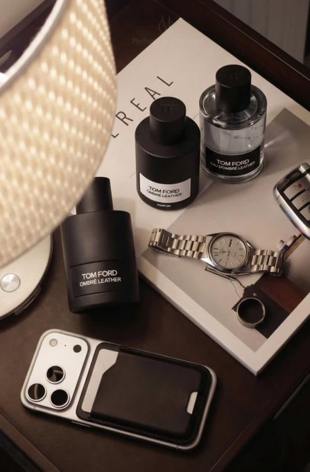 The image features a collection of items placed on a wooden table, including two bottles of perfume, a watch, a cell phone, and a book titled "Happy Friday gTRIA The smoother crypto becomes to use, the faster people stop treating it like future tech". The objects are arranged in an organized manner, with each item having its own designated spot. This arrangement suggests that someone has taken the time to carefully arrange their belongings on the table, possibly for personal enjoyment or as a way to keep their space tidy and visually appealing.

The post about crypto seems unrelated to the items displayed on the table. It is important to note that the image does not provide enough context to determine whether the content of the post is relevant to the objects present in the scene.