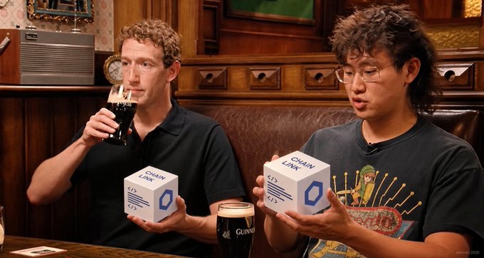 A digitally edited image shows Mark Zuckerberg drinking a Guinness beer while holding a box labeled 'CHAIN LINK', seated next to a man in a t-shirt holding an identical 'CHAIN LINK' box.