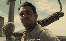 A man with a noose around his neck smiling calmly, with caption text: '...first time?'