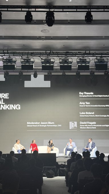 A panel discussion on stage at a banking conference, moderated by Jason Blum (Global Head of Strategic Partnerships, OKX), with panelists including Bay Thuraisingham, Amy Tian, Luke Boland, and David Fragile.