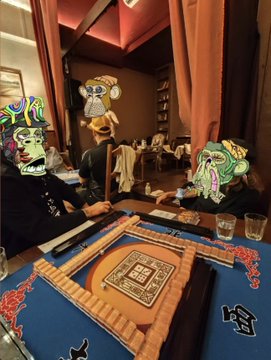 Two people wearing colorful Bored Ape Yacht Club-style masks play mahjong at a blue table inside a dimly lit lounge, with the post thanking the hosts for an incredible evening.