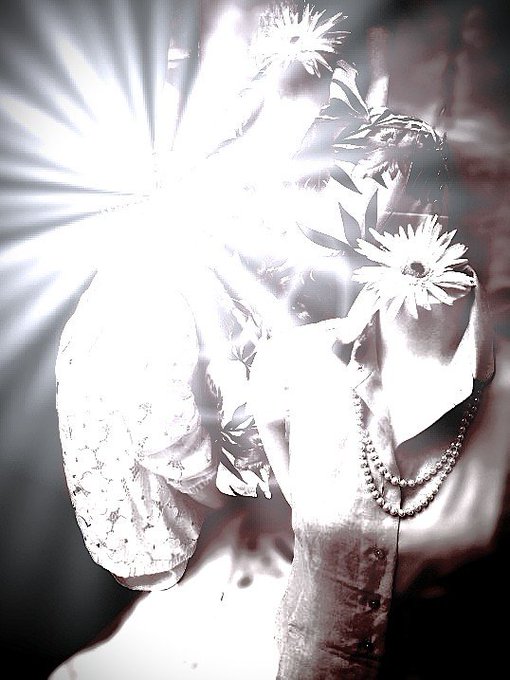 A high-contrast black-and-white image of gloved hands adorned with pearl bracelets and daisies, bathed in a starburst of bright light.
