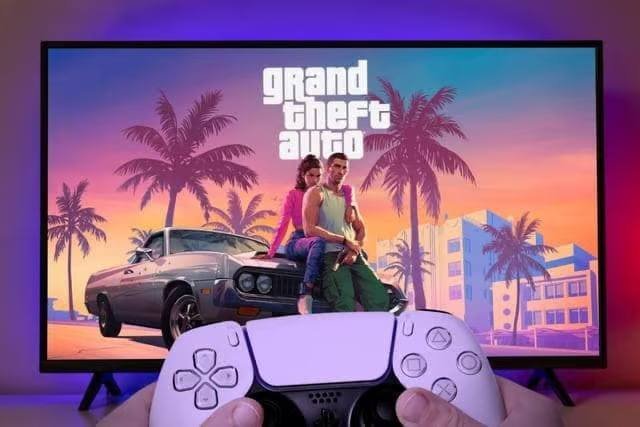 A person holds a white PlayStation 5 DualSense controller in front of a TV displaying the "Grand Theft Auto" logo with characters leaning against a car, visually tying to the post's discussion of the GTA 6 leak tied to hacker "CyberLeek," who demanded 400 XMR (Monero cryptocurrency) to fund an unspecified future project against the gaming industry.