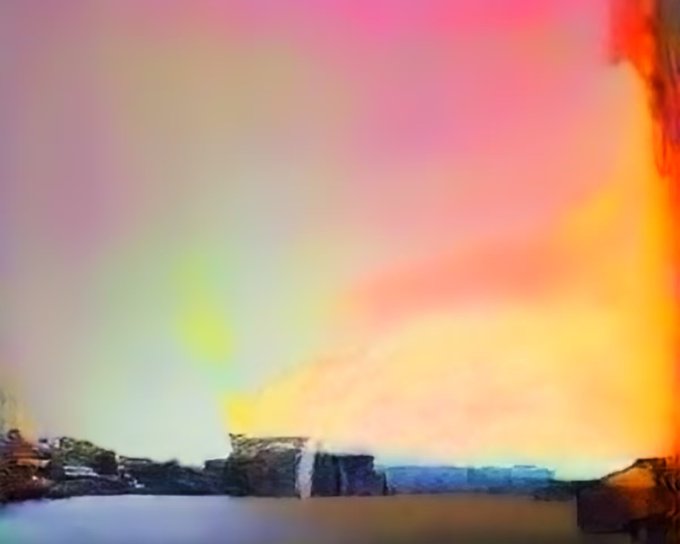 An abstract, impressionistic image with vibrant pink, orange, yellow, and green colors dominating the sky above a faint landscape silhouette.