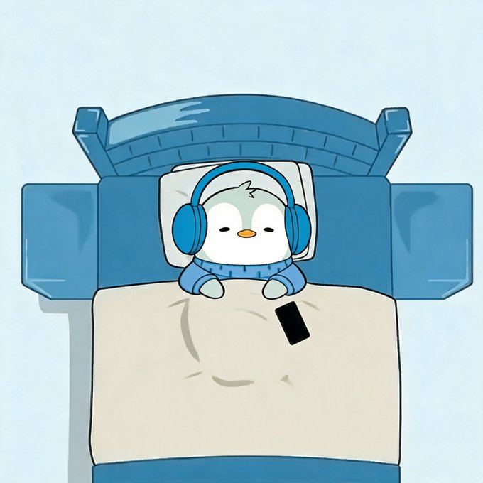 A cute cartoon illustration of a small penguin-like character wearing blue headphones and a blue sweater, sitting up in bed under a beige blanket with a smartphone resting on the covers.