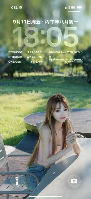 A lock screen showing the time 18:05, date 9月11日周五 (Friday, September 11), and crypto prices for BTC/USDT, ETH/USDT, and OKB/USDT, featuring a wallpaper of a woman sitting at a table.