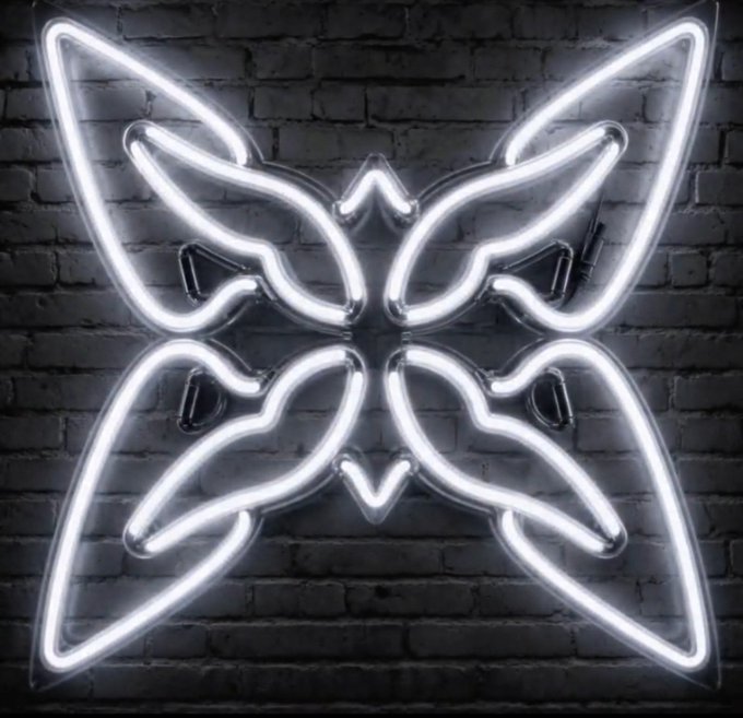A bright white neon light shaped like a symmetrical butterfly design mounted on a dark brick wall.
