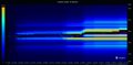 An abstract, motion-blurred image with vertical streaks of deep blue, purple, and hints of yellow and green light.