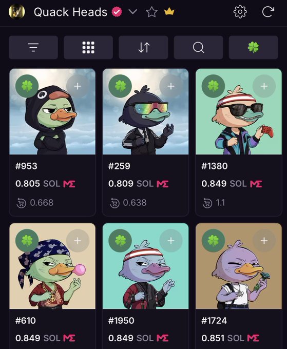 The image features a display of various cartoon duck characters wearing costumes, all with different poses and expressions. There are nine unique duck characters in total. The post itself consists of descriptions about these cartoon duck heads including their names, descriptions, and prices. It is related to the quote "Quack Heads Giá mint: 2.5 Sol (~$400) Giá ATH: 6 Sol (~$800) Giá hiện tại: 0.8 Sol (~$58) Anh em còn Hold hay đã bán rồi! @wallchain còn Quack Quack nổi nữa không bạn?".
