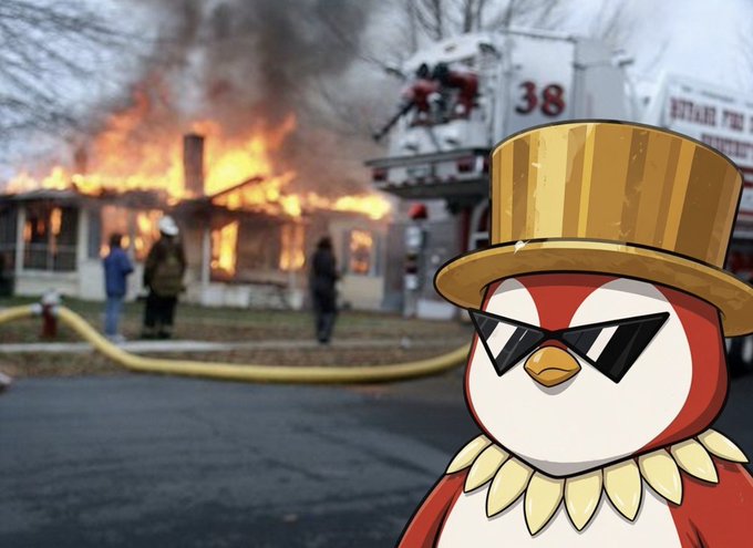A cartoon penguin wearing sunglasses and a gold top hat poses in front of a burning house with firefighters (truck marked "38" and "PITMAN") battling the blaze outside, humorously matching the post's self-deprecating complaint about losing "aura" on KaitoAI.