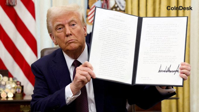 The image shows Donald Trump signing an official document in front of the United States flag. The accompanying post notes that the White House is confirming the U.S. Strategic Bitcoin Reserve is still being structured 16 months after his executive order, which indicates that this particular document signed by former President Trump could be related to cryptocurrency regulation or legislation.