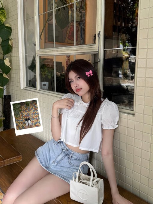 The image features a woman sitting at a table with her legs crossed while wearing a white top and blue shorts. She has a handbag placed next to her on the table. The background of the image shows a window, which could be part of a building or an outdoor setting. There is also a picture hanging on the wall behind the woman.

The post seems to be discussing Bitcoin and its value in relation to altcoins. It questions whether Bitcoin can drag altcoins up, implying that it has the power to increase their worth. The image does not provide any concrete evidence or logical explanation for this claim, but rather presents a speculative scenario.