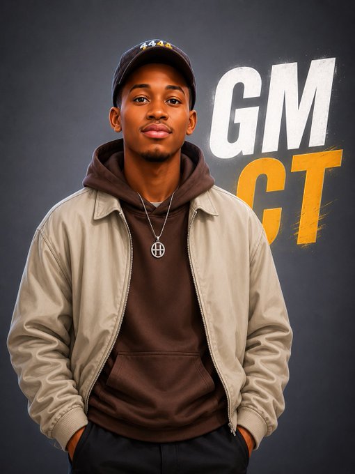 A portrait of a young man wearing a beige jacket over a brown hoodie and a cap, with the text 'GM GT' displayed in white and orange letters on a dark background.
