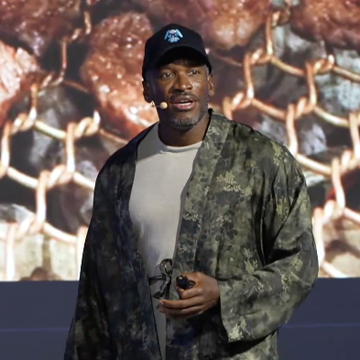 A man wearing a blue cap, white shirt, and camouflage jacket speaks on stage while holding a microphone, standing in front of a backdrop with a wire-mesh pattern.

The image relates to the post about stablecoins, Bitcoin, and the $FLOP token, suggesting the speaker is likely promoting $FLOP as a new cryptocurrency while presenting at what appears to be a tech or finance event.