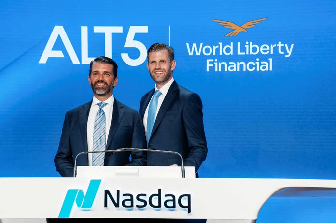 Two men in suits stand at a Nasdaq podium beneath banners reading "ALT5" and "World Liberty Financial."