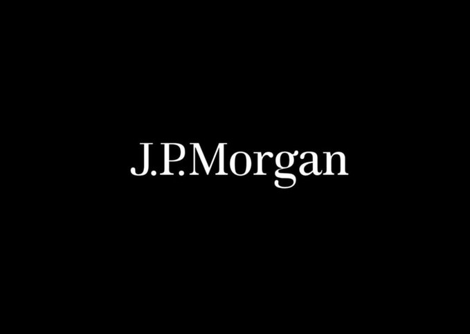 The image features a black background with white text that reads "J.P. Morgan". Below this, there are two lines of text written in white, which read "just settled through a tokenized U.S. Treasury transaction on the XRP Ledger." The image also includes an image of a person holding a wallet and a cell phone.