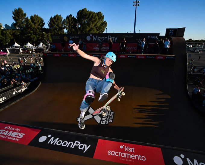 A female skateboarder wearing a blue helmet performs an aerial trick above the ramp at the X Games Sacramento, with prominent "MoonPay" and "Visit Sacramento" sponsorship signage lining the halfpipe—visually reinforcing the post's message about MoonPay's role in driving the X Games League's 78.5% YoY viewership growth across major U.S. and Japanese host cities.