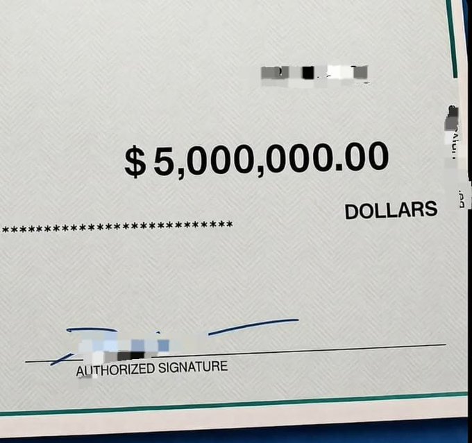 A check displaying the amount '$5,000,000.00 DOLLARS' with a redacted authorized signature line.
