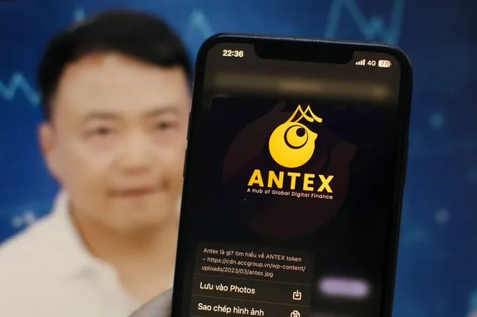 A smartphone displaying the ANTEX logo with the tagline 'A Hub of Global Digital Finance' about ANTEX token, shown in front of a blurred image of Jack Ma.
