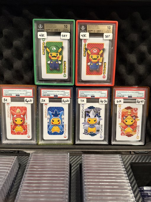 Graded Beckett-encased Pokemon playing cards featuring Pikachu dressed as Mario, with labels showing grades and prices like '4K SET', '3K', '7K', and '6K'.