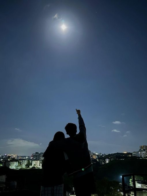 A silhouetted couple stands together under a moonlit sky, with one person pointing up toward the bright moon, capturing a quiet, reflective moment that echoes the post's themes of closing out the day and looking ahead to new opportunities together.