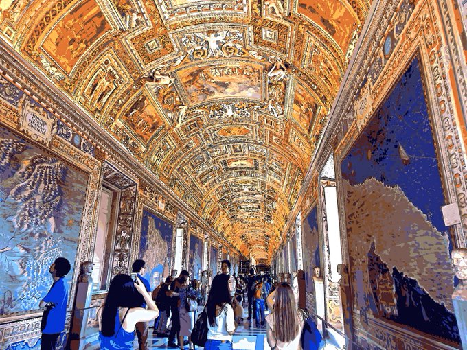 The image shows a group of people walking through an ornate hallway with large paintings on the walls, creating a sense of grandeur and elegance. The people are dressed in formal attire, suggesting that they might be attending a special event or gathering. There is also a handbag visible among the crowd, indicating that some individuals may have brought personal belongings with them as they explore the space. The overall atmosphere appears to be one of sophistication and refinement, with the group moving through the hallway together.