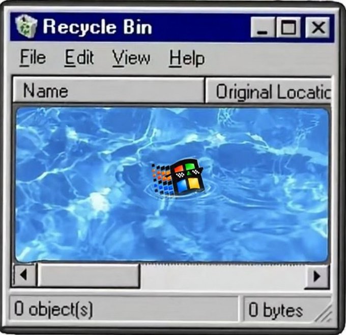 A classic Windows XP Recycle Bin window, showing an empty bin with 0 objects and 0 bytes, featuring the iconic blue water background and Windows logo.
