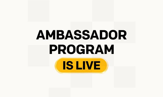A simple graphic on a checkered background with bold text reading 'AMBASSADOR PROGRAM IS LIVE' highlighted in a yellow pill-shaped badge.