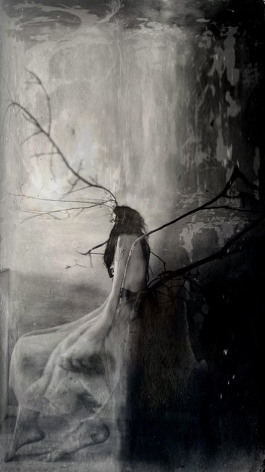 A monochromatic, atmospheric painting portrays a figure in a long, flowing dress carrying a large, bare tree branch across their shoulders in a dark, ethereal landscape.
