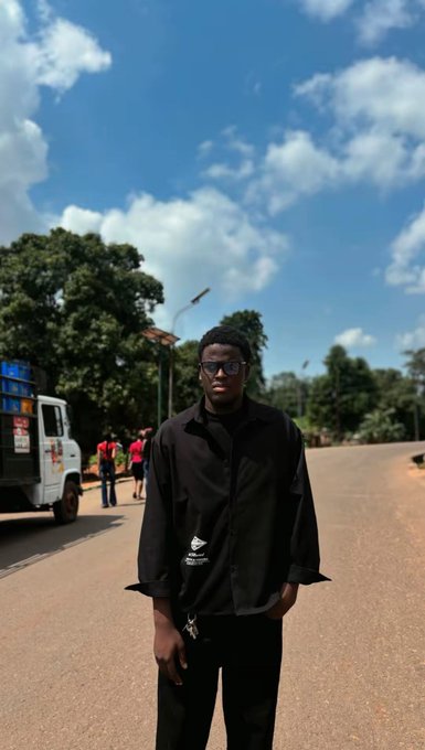 A young man wearing a black Umbro jacket and sunglasses stands confidently on a sunlit road with a truck and other people visible in the background. The post suggests he's seeking advice from both Web3 and Web2 communities, with his confident, stylish pose possibly reflecting the uncertainty of choosing between the two tech worlds.