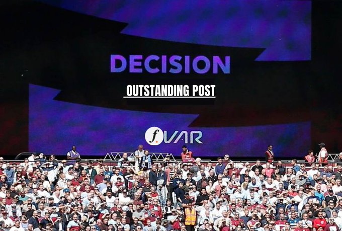 A large stadium screen displays the text 'DECISION' and 'OUTSTANDING POST' above a crowd of spectators, with a 'fWAR' logo visible on the screen.