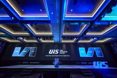 An empty conference room with blue-lit ceiling panels and large screens displaying a logo that reads 'U/S technology', likely UBS.