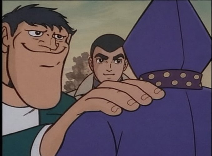 Two animated male characters are shown, with one reaching toward a figure in a purple hooded cloak in what appears to be a classic cartoon style.