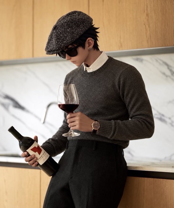 A stylish young man in a herringbone flat cap, sunglasses, gray sweater, and dark trousers pours red wine from a bottle with a red label into a glass while leaning against a marble countertop, perfectly capturing the relaxed Friday evening vibe.