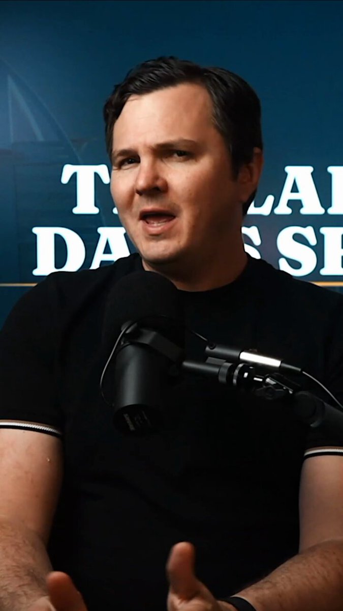 The image features a man wearing a black shirt, standing in front of a microphone with his hands outstretched as if he's giving a speech or presentation. The background shows a blue wall with white text that reads "THE DANCE SHOES". The caption at the bottom of the image states "HYPE had a spectacular week and the math behind is mind-blowing!".