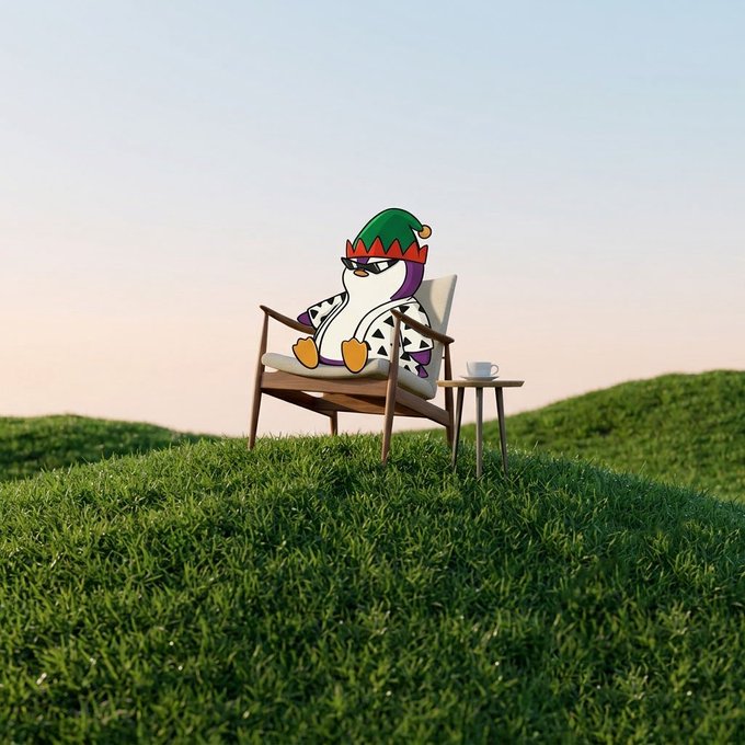 The image features a cartoon penguin sitting comfortably in an empty wooden chair, wearing a green hat with a red bow around its neck. Next to the chair, there's a small table holding a cup of coffee and a saucer. The scene is set against a beautiful landscape with rolling hills under a clear blue sky. The post that accompanies this image reads: "aura farming on this lovely saturday morning".
