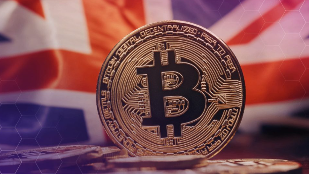 A physical Bitcoin coin featuring the "B" logo and inscriptions reading "BITCOIN DIGITAL DECENTRALIZED PEER TO PEER" rests on a surface with the Union Jack flag of the United Kingdom in the background. The image visually reinforces the post's message about UK banks completing pioneering tokenized deposit transfers on blockchain technology, symbolizing the intersection of traditional British finance and digital currency innovation.