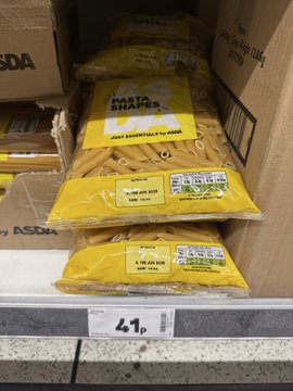 Bags of 'Pasta Shapers' sit on a grocery store shelf next to a price tag reading '4,47,' with product text in both English and Italian.