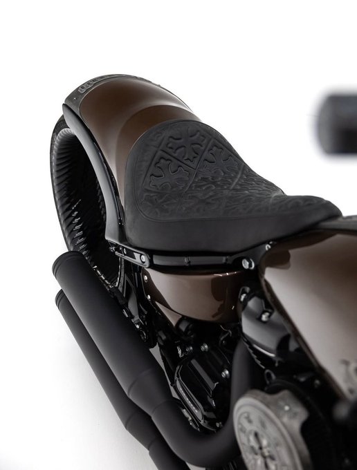 A close-up product photograph of a high-end cycling shoe featuring a leather upper, BOA dial closure system, and a textured footbed, displayed against a white background.