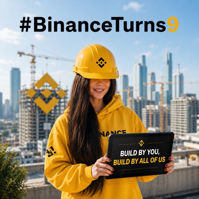 A promotional graphic featuring a woman in a yellow hard hat and hoodie holding a tablet that reads 'BUILD BY YOU, BUILD BY ALL OF US,' with the hashtag #BinanceTurns9 and a cityscape background.