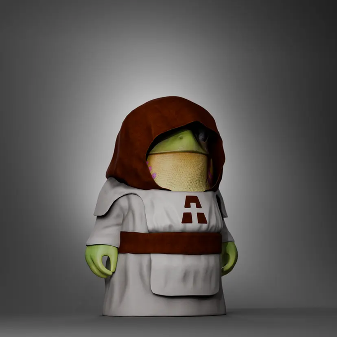 A figurine/collectible of a green frog character dressed in Jedi robes, featuring a brown hood and cream-colored tunic with a red lightsaber hilt symbol on the chest, rendered in a 3D style against a gray gradient background.