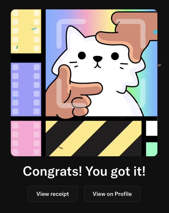 The image features a cartoon cat holding up two fingers as if posing for a picture. The background of the image has various colors, including pink, blue, yellow, green, and purple. There are also some text elements present in the image, such as "Congratulations! You got it!" and "View on Profile".