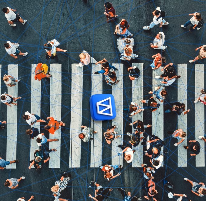 An aerial view shows a crowd of people crossing a zebra-striped crosswalk, with blue digital lines connecting them and a large blue app icon featuring a white arrow symbol floating in the center.
