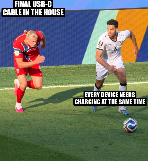 A meme image showing two soccer players chasing a ball, with text reading 'FINAL USB-C CABLE IN THE HOUSE' on the left player and 'EVERY DEVICE NEEDS CHARGING AT THE SAME TIME' on the right player.